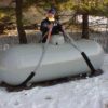 Serviceman placnig a strap around a propane tank