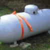 Propane tank equipped with an orange lifting strap