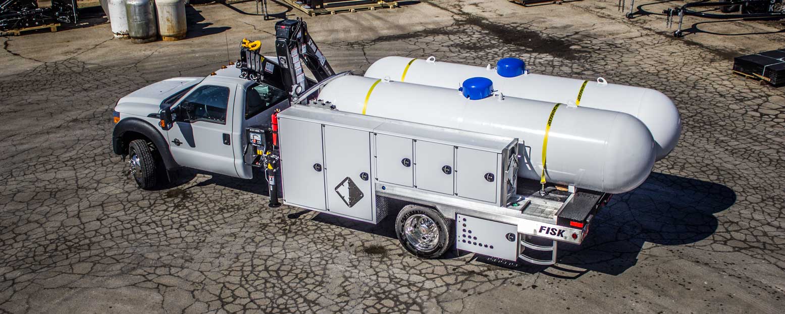 Stick boom truck with two propane tanks