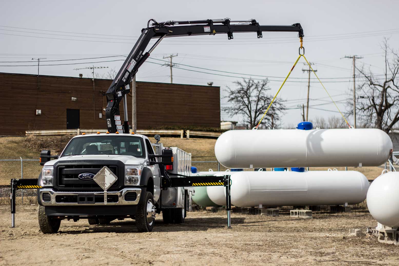 truck with crane holding tanks