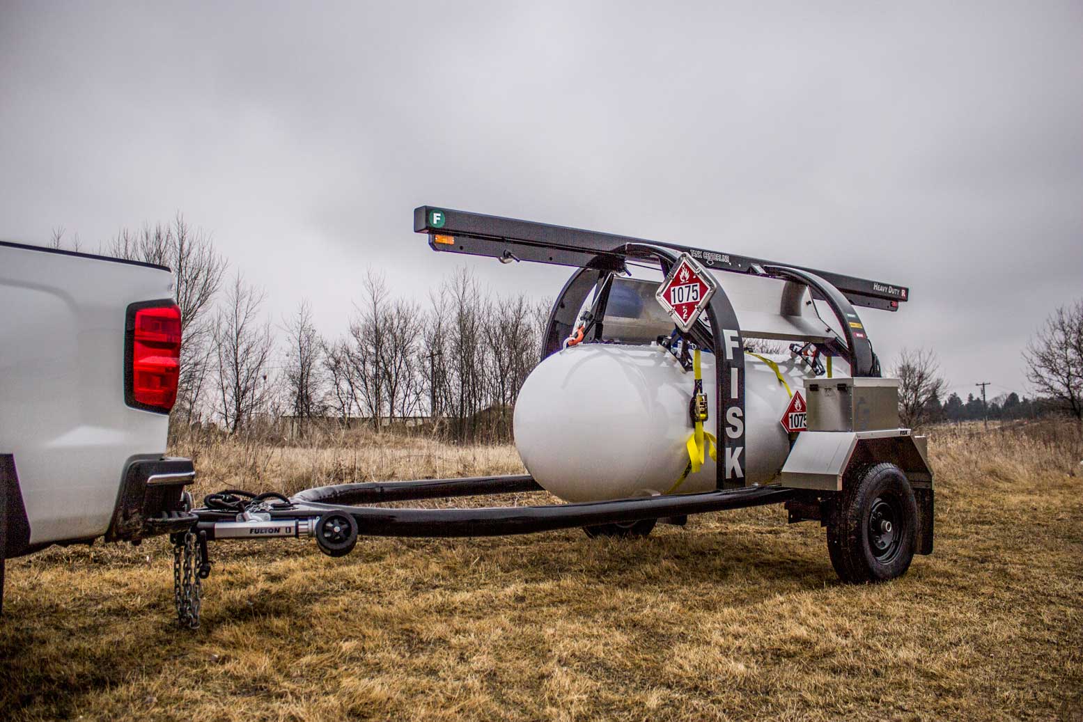 Propane hauling trailer attached to a truck