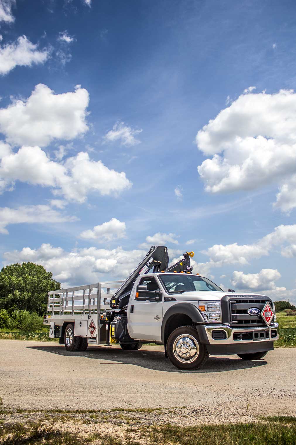 white truck with crane and trailor