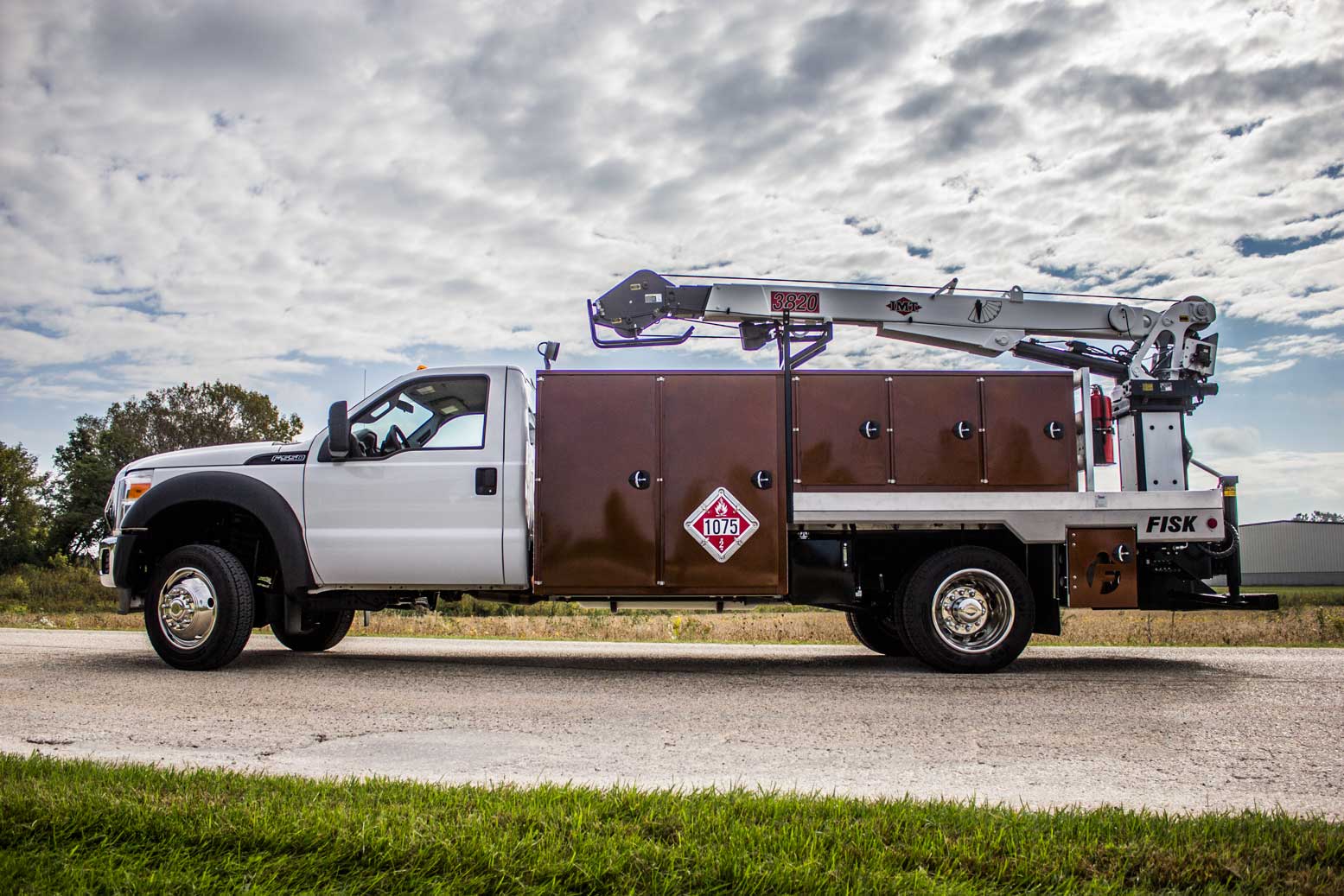 Left side view of a propane stick boom truck