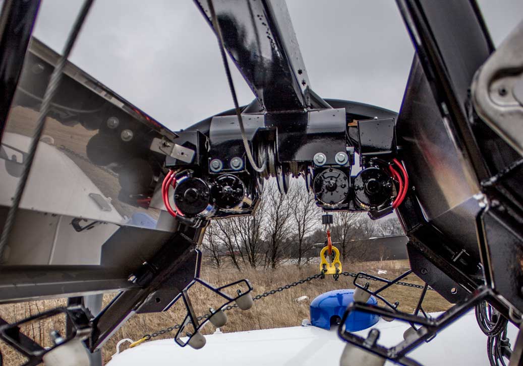 Dual winch motors on a propane service trailer