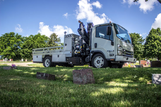 Knuckle boom truck in a cemetary