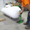 Man operating a propane tank jack