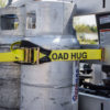 Load hug strap wrapped around propane bottles