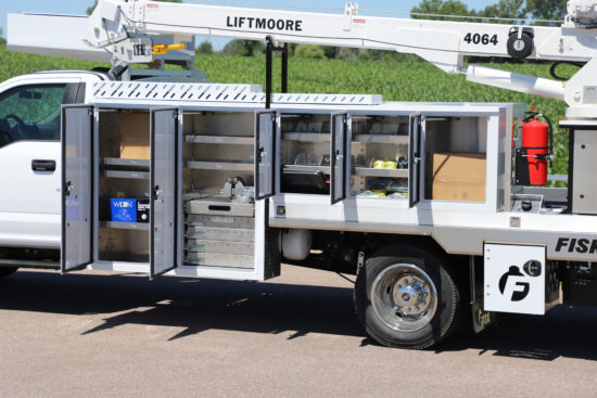 A white utility truck with a lift moore crane with the doors open