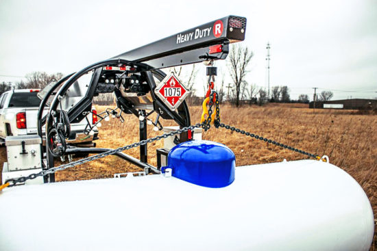 A black propane trailer from Fisk carrying a large propane tank