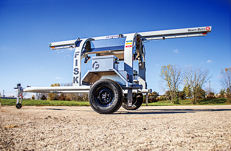 A gray propane transport trailer from Fisk parked outside